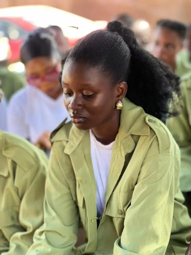 Dorcas in NYSC uniform looking frustrated, a story about the Nigerian banking system and trusting God's timin