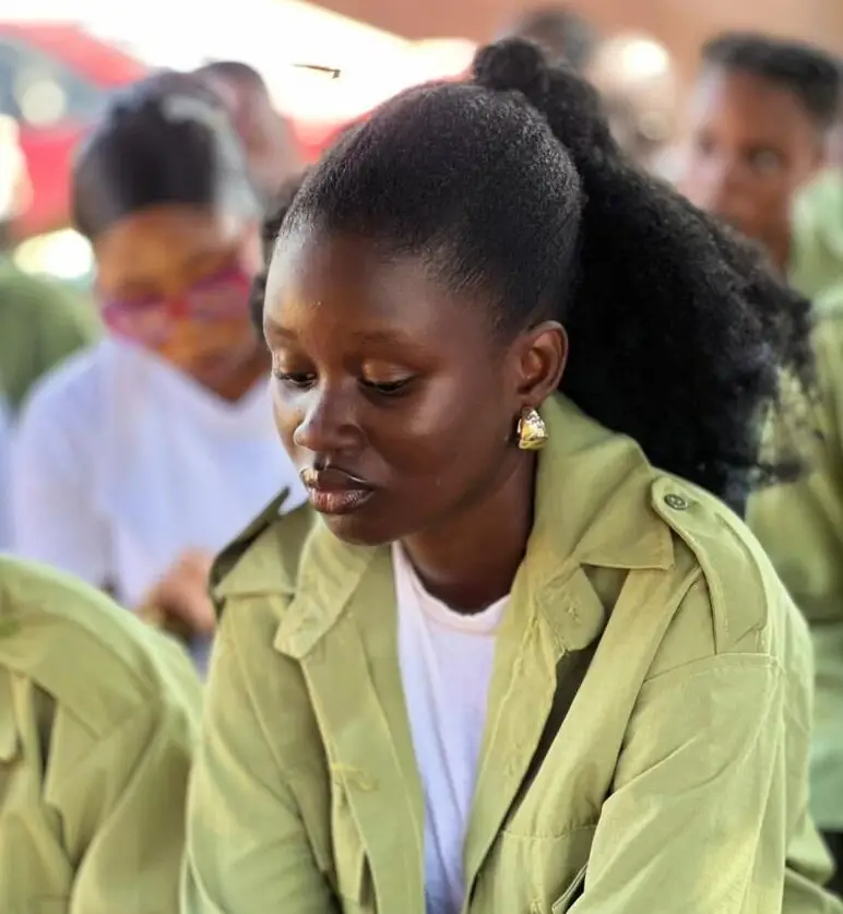 Dorcas in NYSC uniform looking frustrated, a story about the Nigerian banking system and trusting God's timin