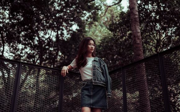 Young adult standing outdoors looking forward with confidence, representing hope and faith after trusting God during hard times